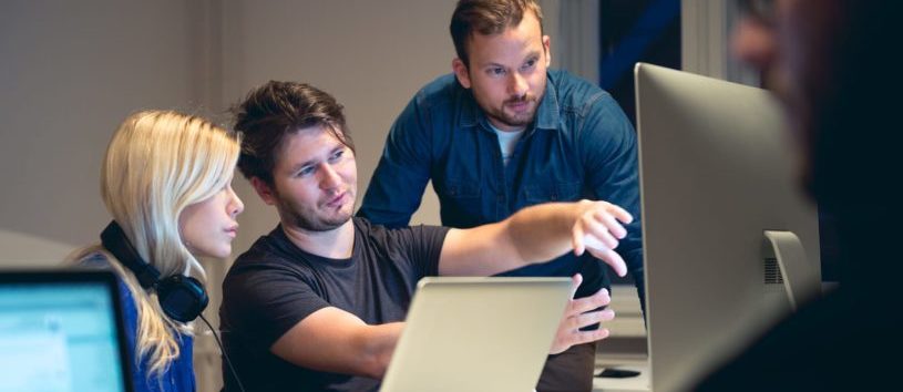 Design professionals looking at a computer.